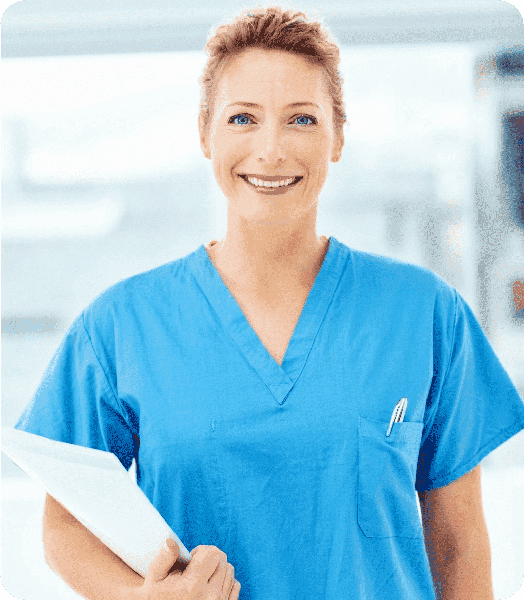 friendly nurse smiling wearing blue scrubs