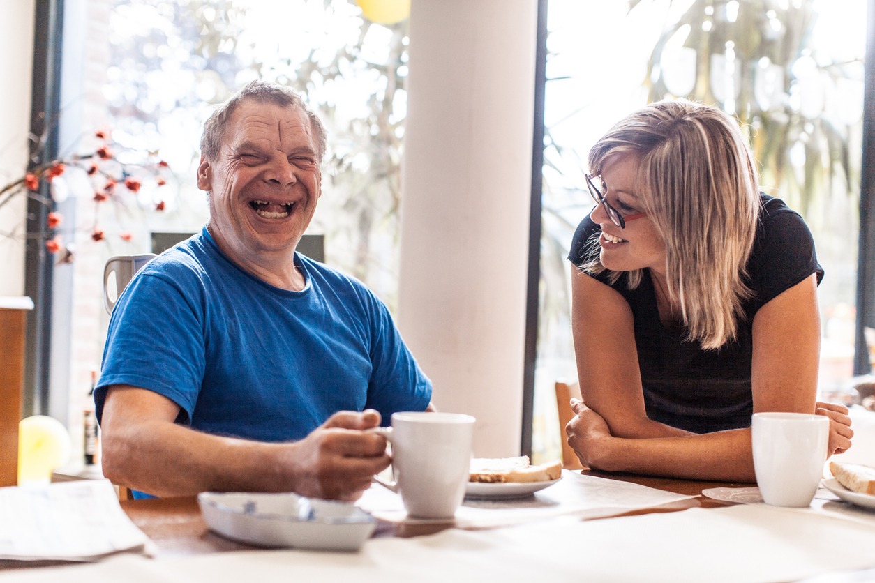 Adult Man Portrait with a Down Syndrome and a Caregiver